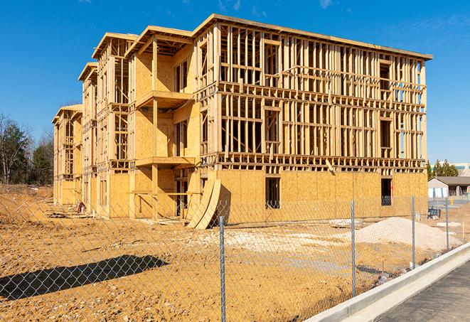 a temporary chain link fence in front of a building under construction, ensuring public safety in Sharonville, OH